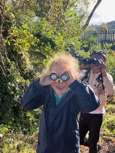 Forest school kids have fun with binoculars
