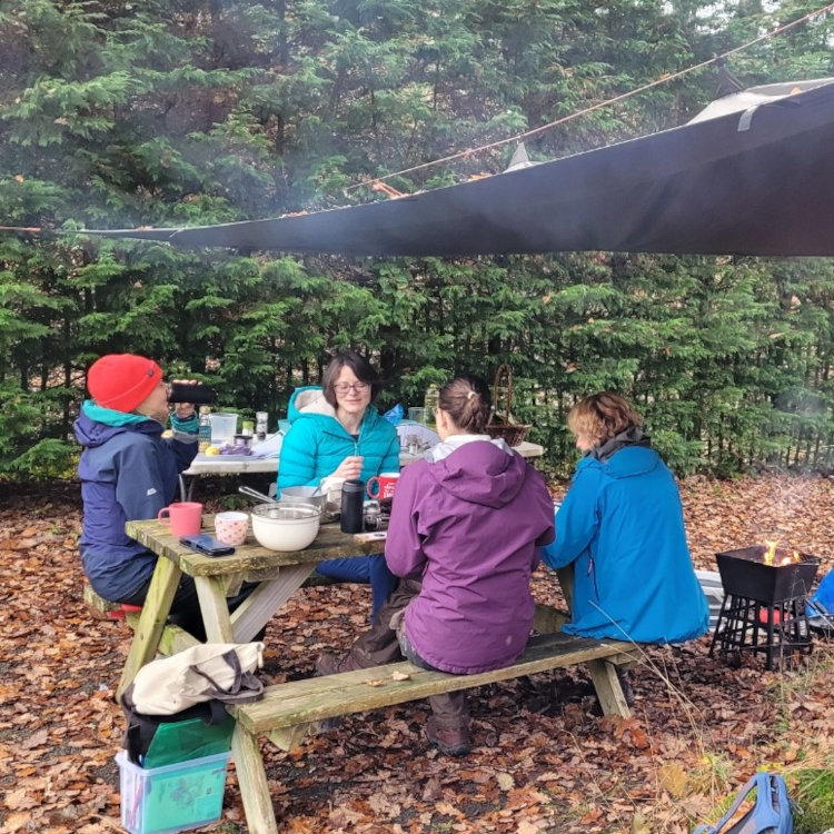 People chatting and eating foraged foods