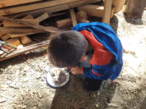 A child practicing fire lighting skills
