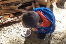 A child practicing fire lighting skills